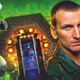 Christopher Eccleston as Doctor Who's Ninth Doctor, in front of the interior of his TARDIS console room and some flying alien drones.